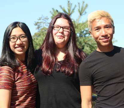 Three smiling students 