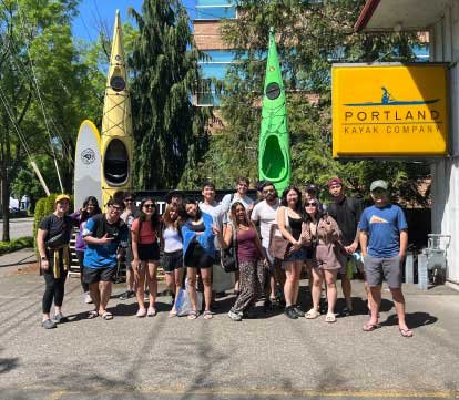 group photo by Portland Kayak Company sign