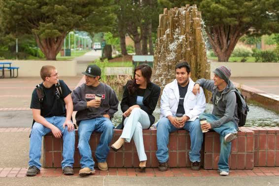 student sitting together at a fountain